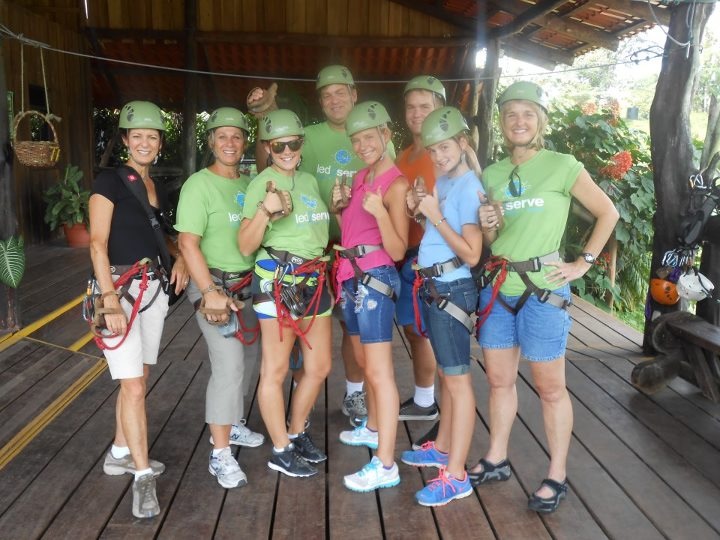 Volunteers in climbing helmets and harnesses ready for adventure