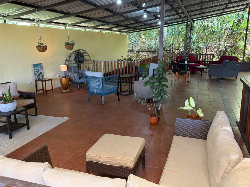 Open-air lounge with wicker seating at Koi Oasis
