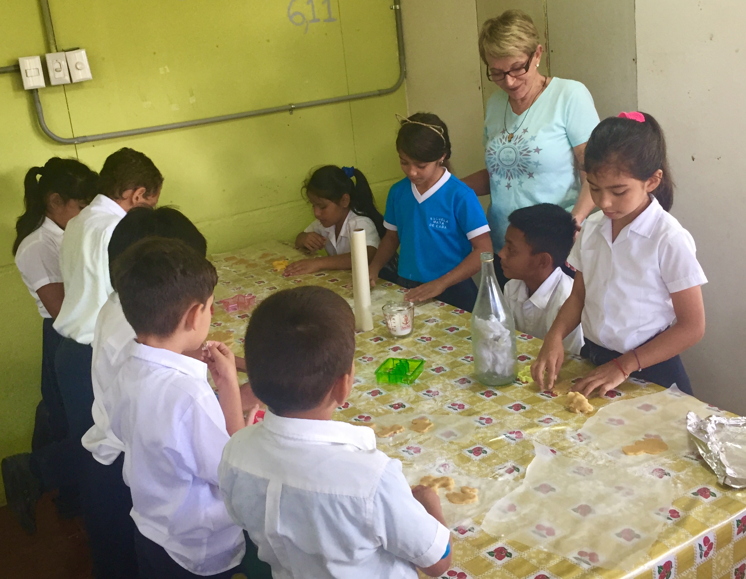 Volunteers baking with local children at a community activity table