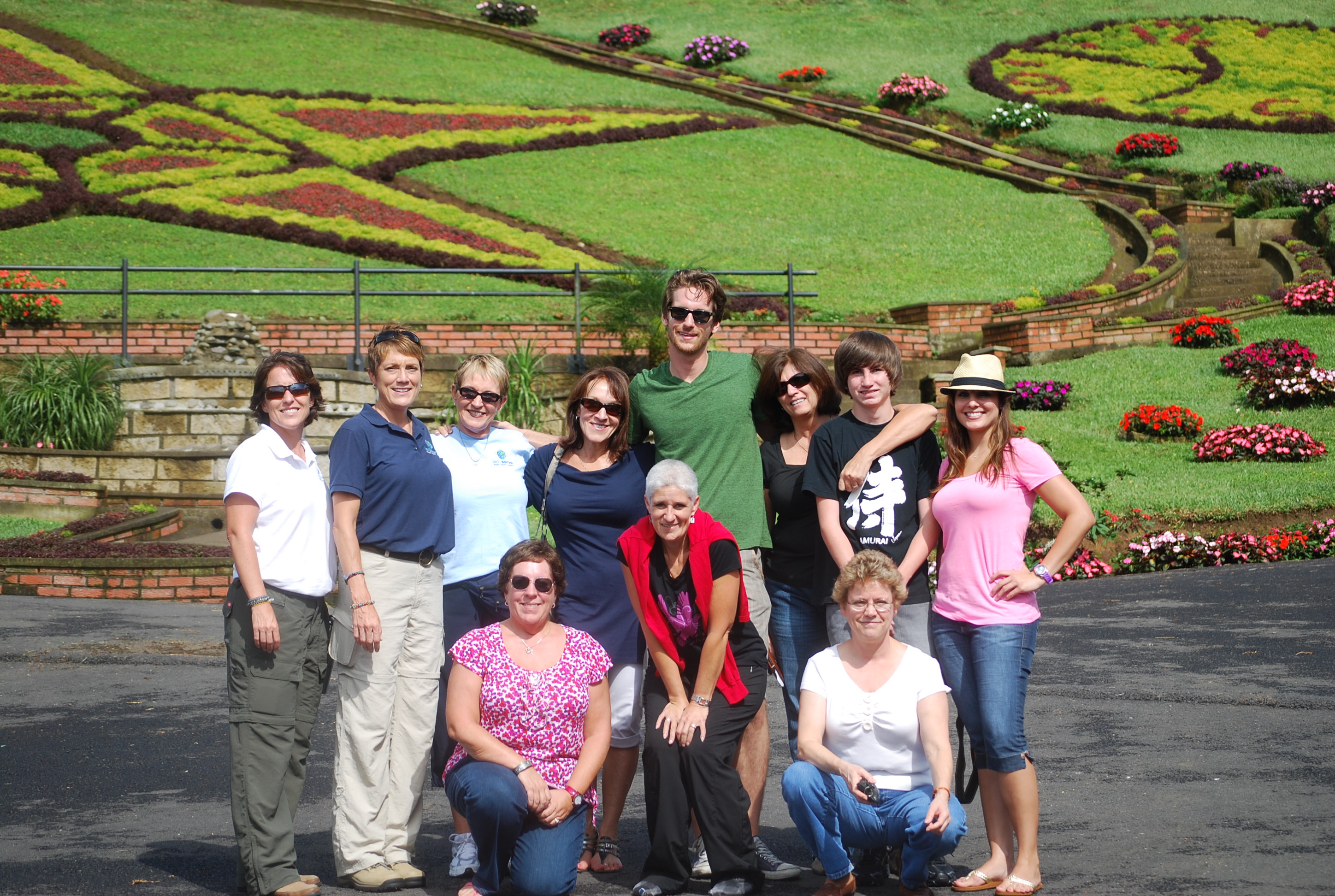 Service team group photo in front of a landscaped garden
