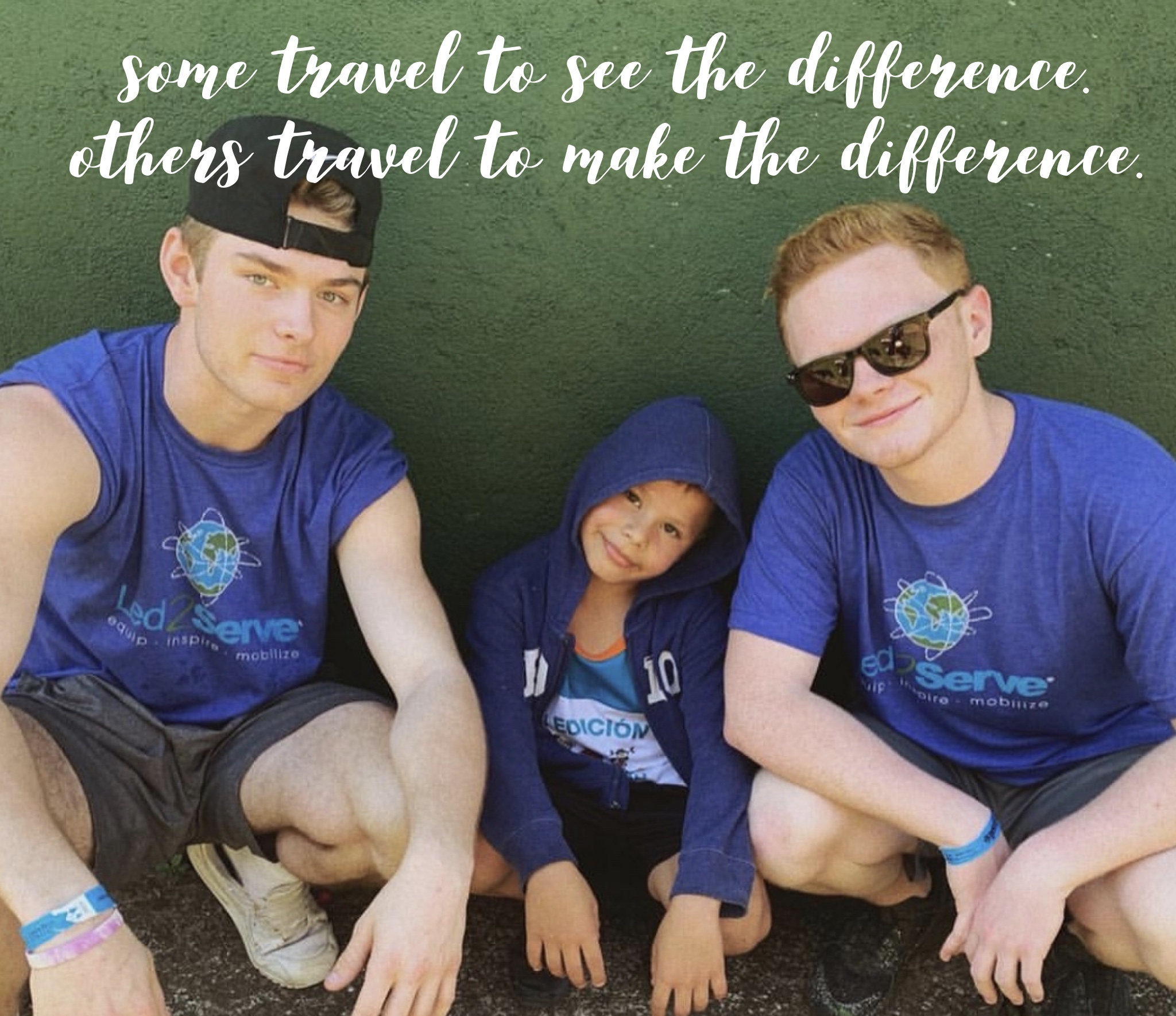 Volunteers with a child — some travel to see the difference, others to make the difference