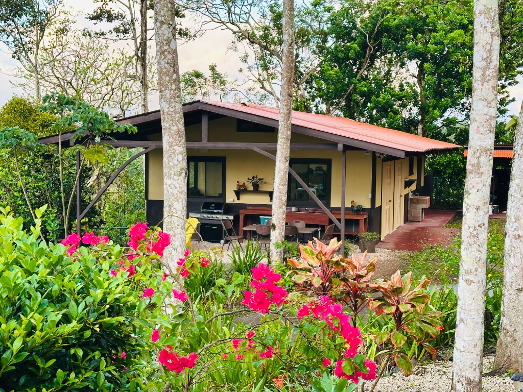 The Koi Cottage exterior with bougainvillea and a covered patio