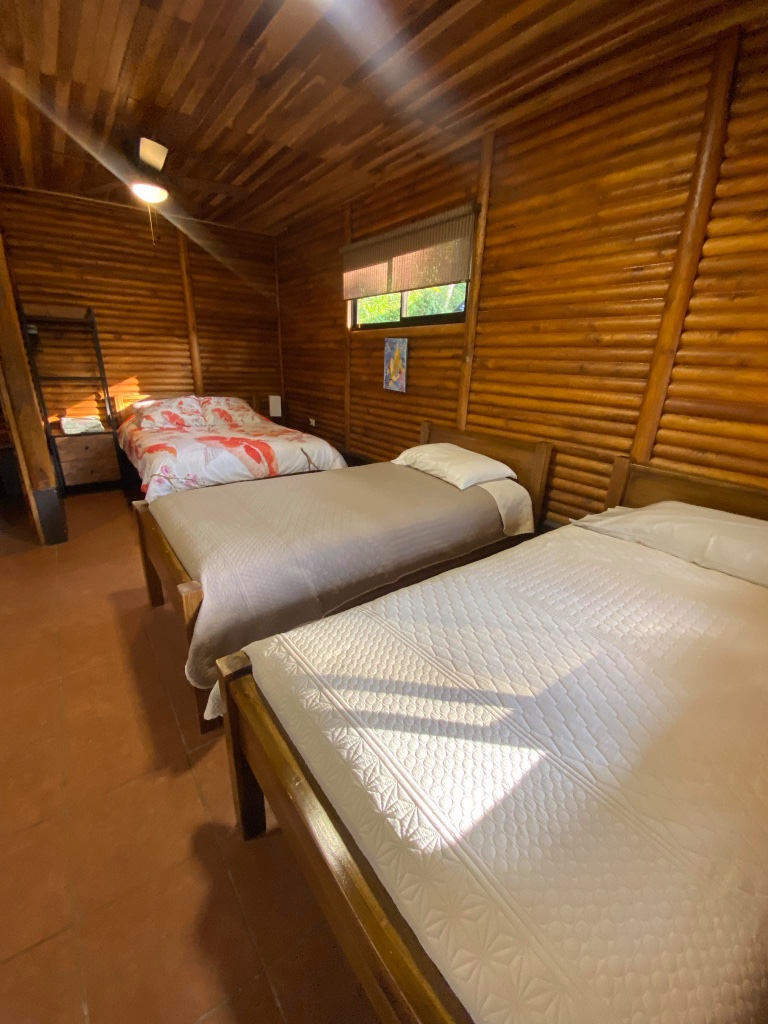 Bedroom with patterned linens inside the cabin