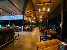 Interior dining area with warm wood and pendant lighting
