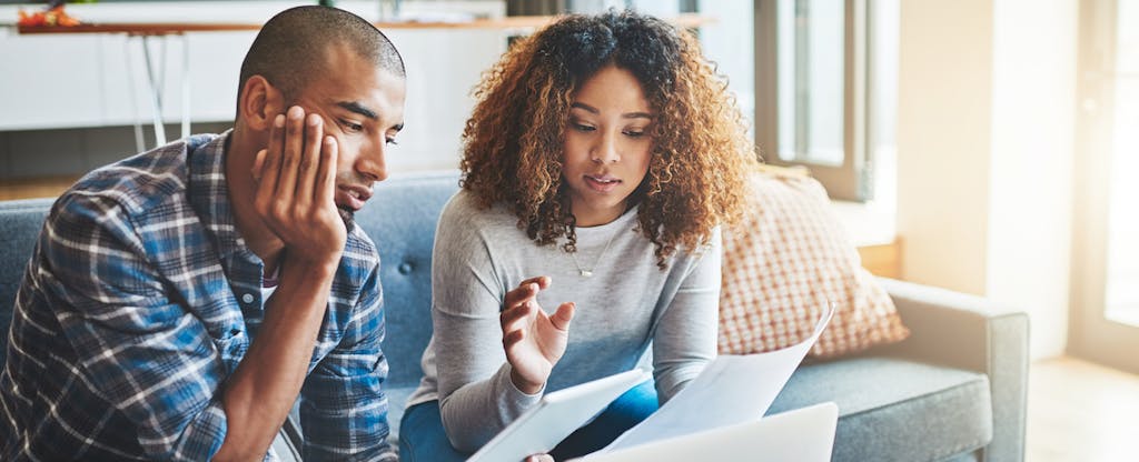 Consumers reviewing debt-collection documents together.