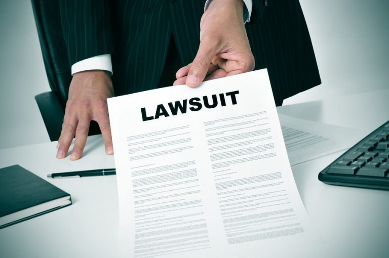 Legal professional presenting a document labeled lawsuit.