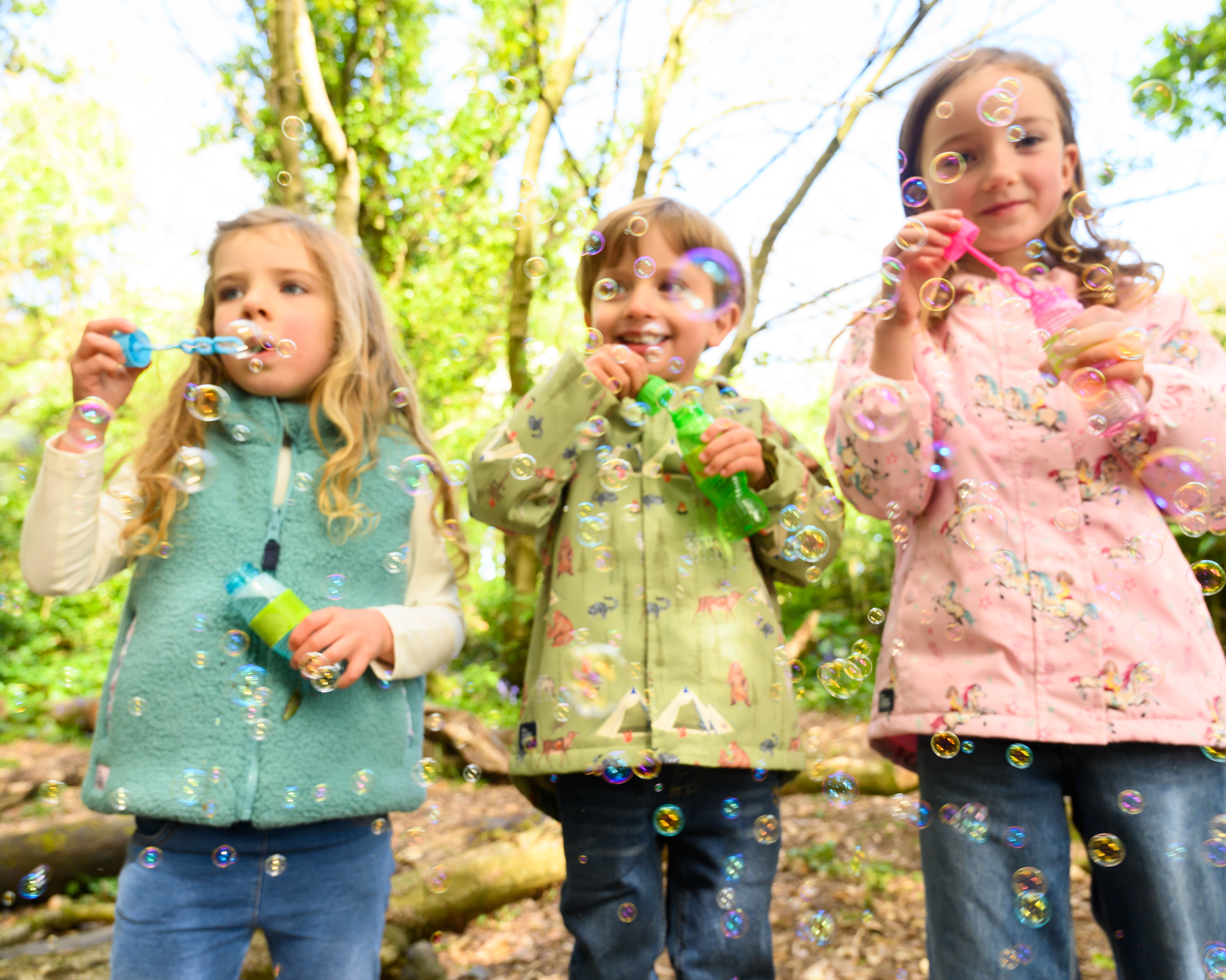 Little Lighthouse - Children blowing bubbles in the forest
