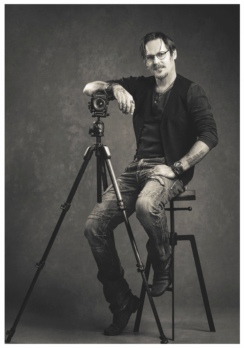 John Adams, studio portrait with a camera on a tripod