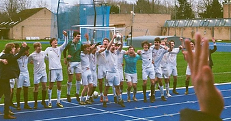 NCAFC celebrating on the track, with the trophy held aloft