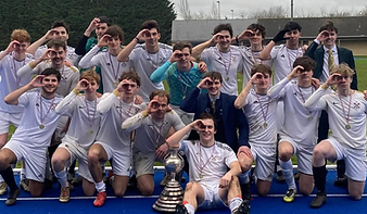 The NCAFC squad posing with a trophy on the athletics track