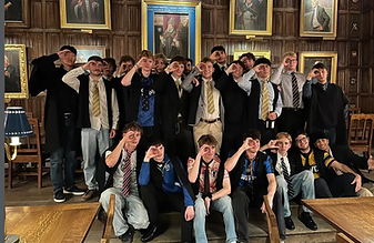 NCAFC members in the wood-panelled hall, in football kits and formal dress