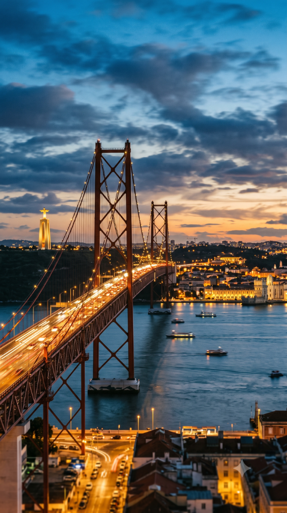 25 de Abril Bridge and Cristo Rei monument over the Tagus River in Lisbon at twilight
