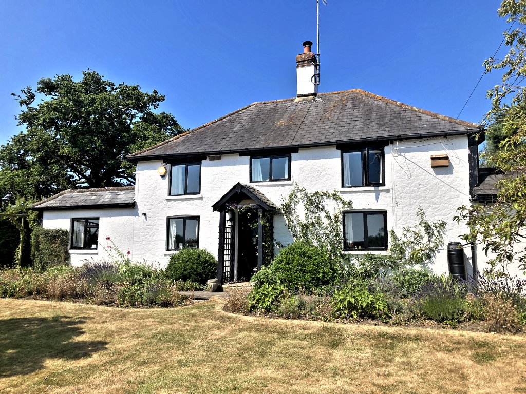 White-rendered detached cottage