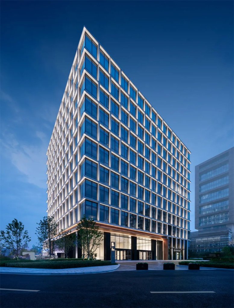 Glass Tower — Lit Fins at Dusk