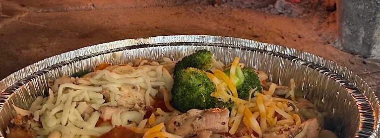 Wood-fired baked pasta bowl fresh from the oven