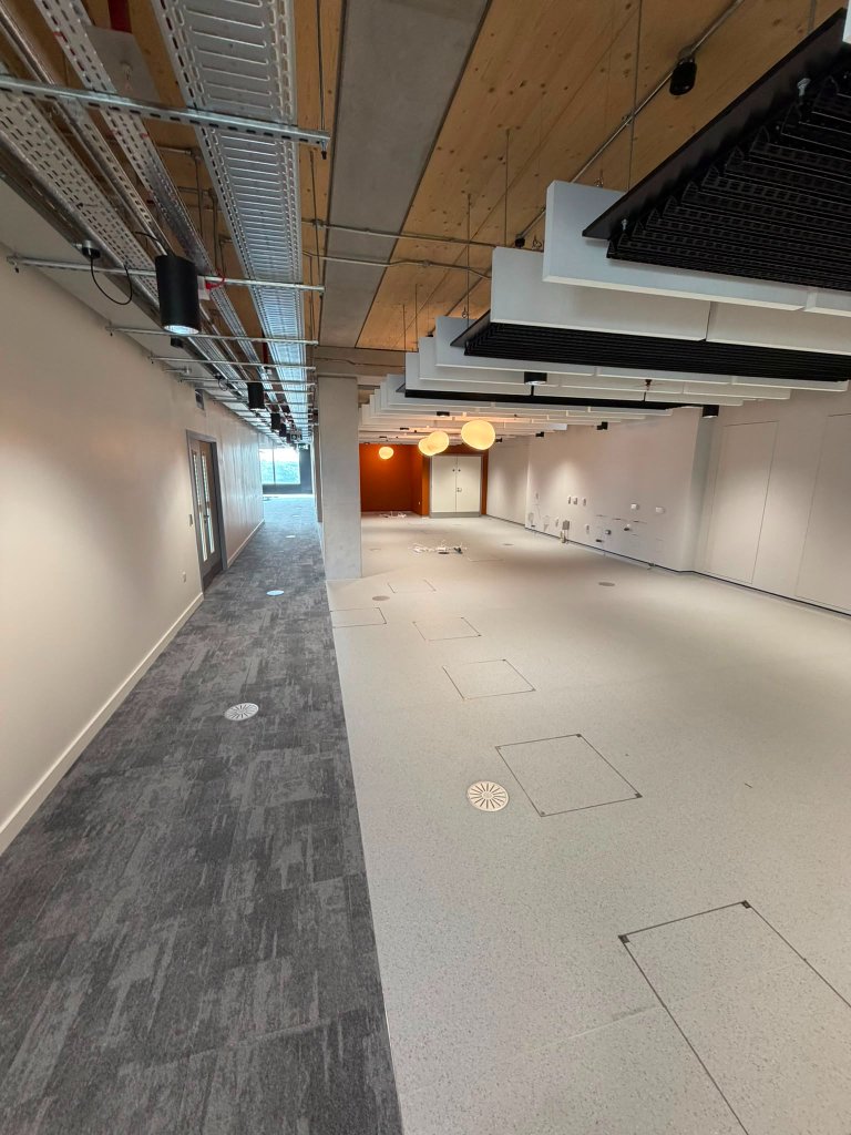 Office floor with decorative lighting and containment overhead