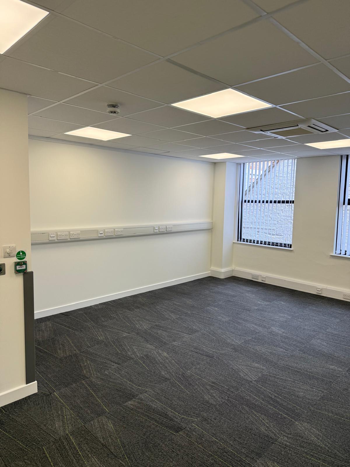 Office room with cable trunking, vertical blinds and emergency push button