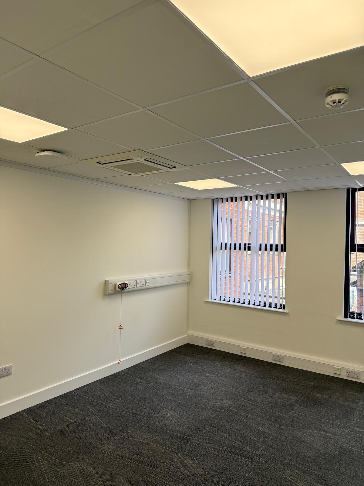 Office room with emergency pull-cord alarm and vertical blinds