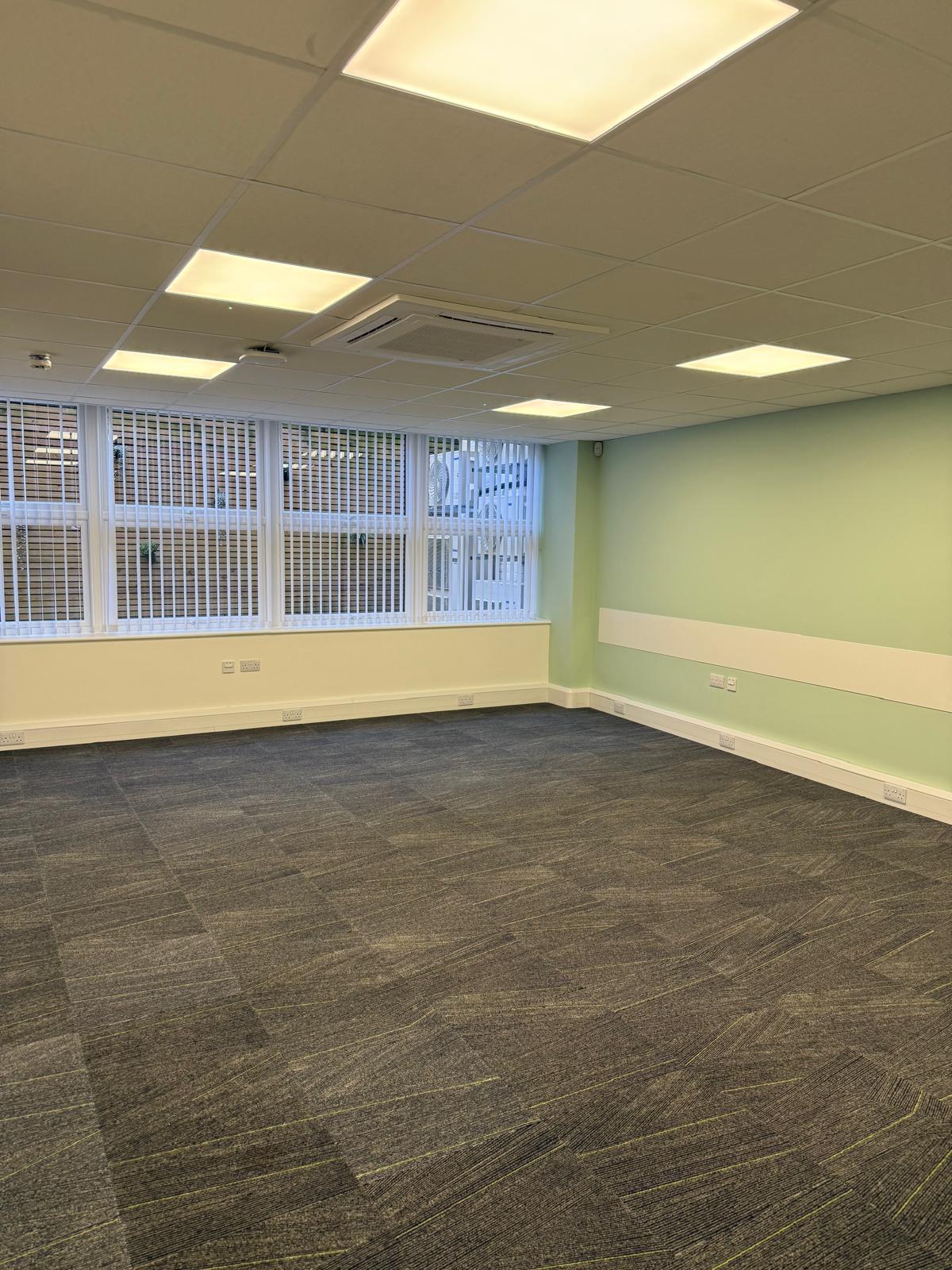 Empty consulting room with vertical blinds and natural light