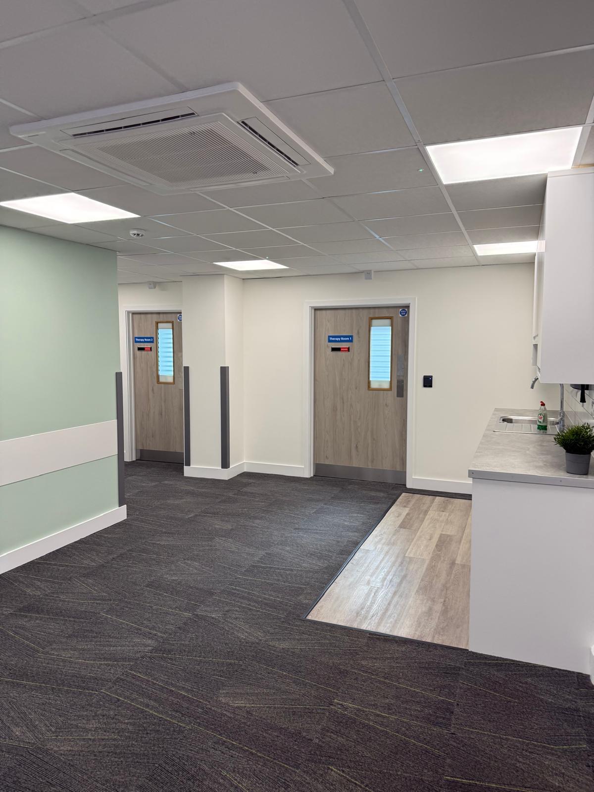 Hallway with Therapy Room 1 & 2 doors and kitchenette area