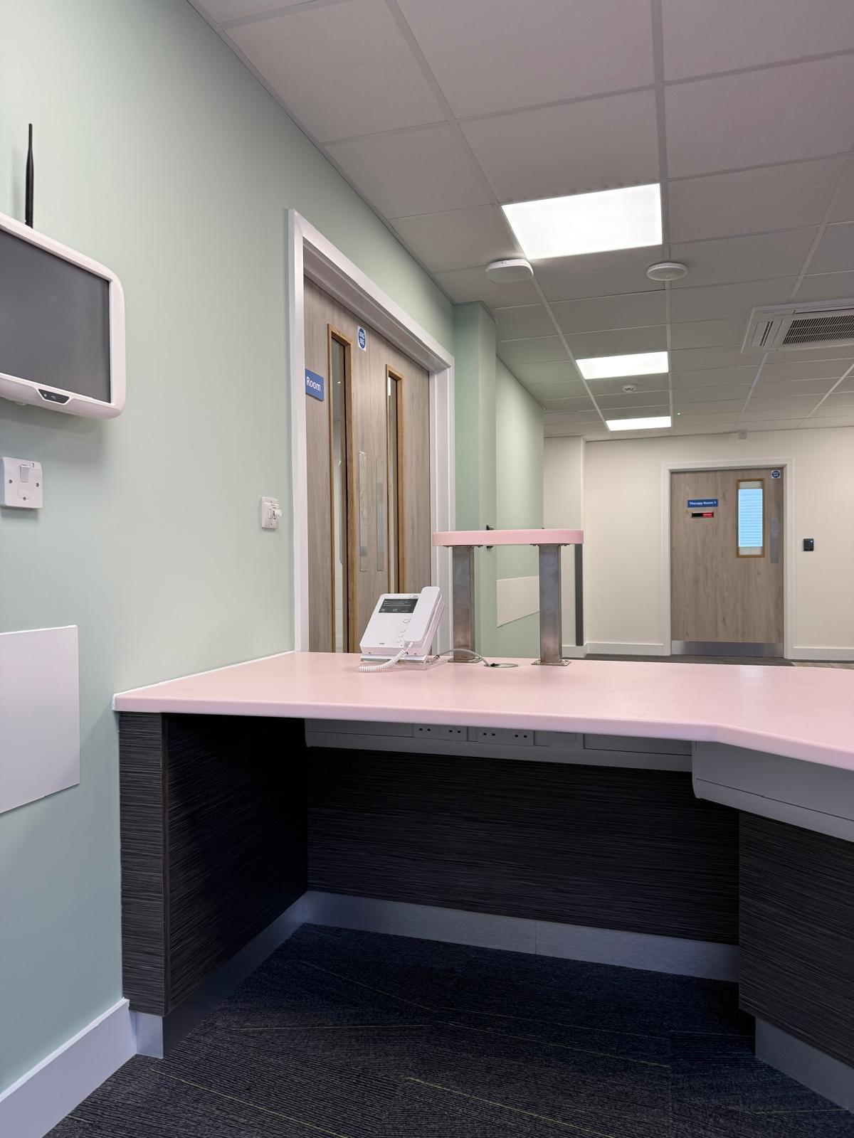 Reception desk with corridor view through Group Room doorway