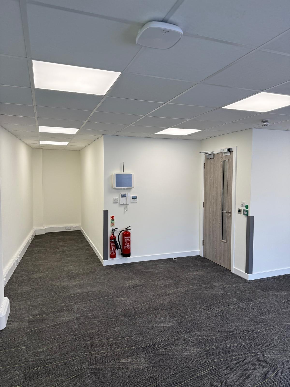 Door with nurse call console, fire extinguishers and emergency release