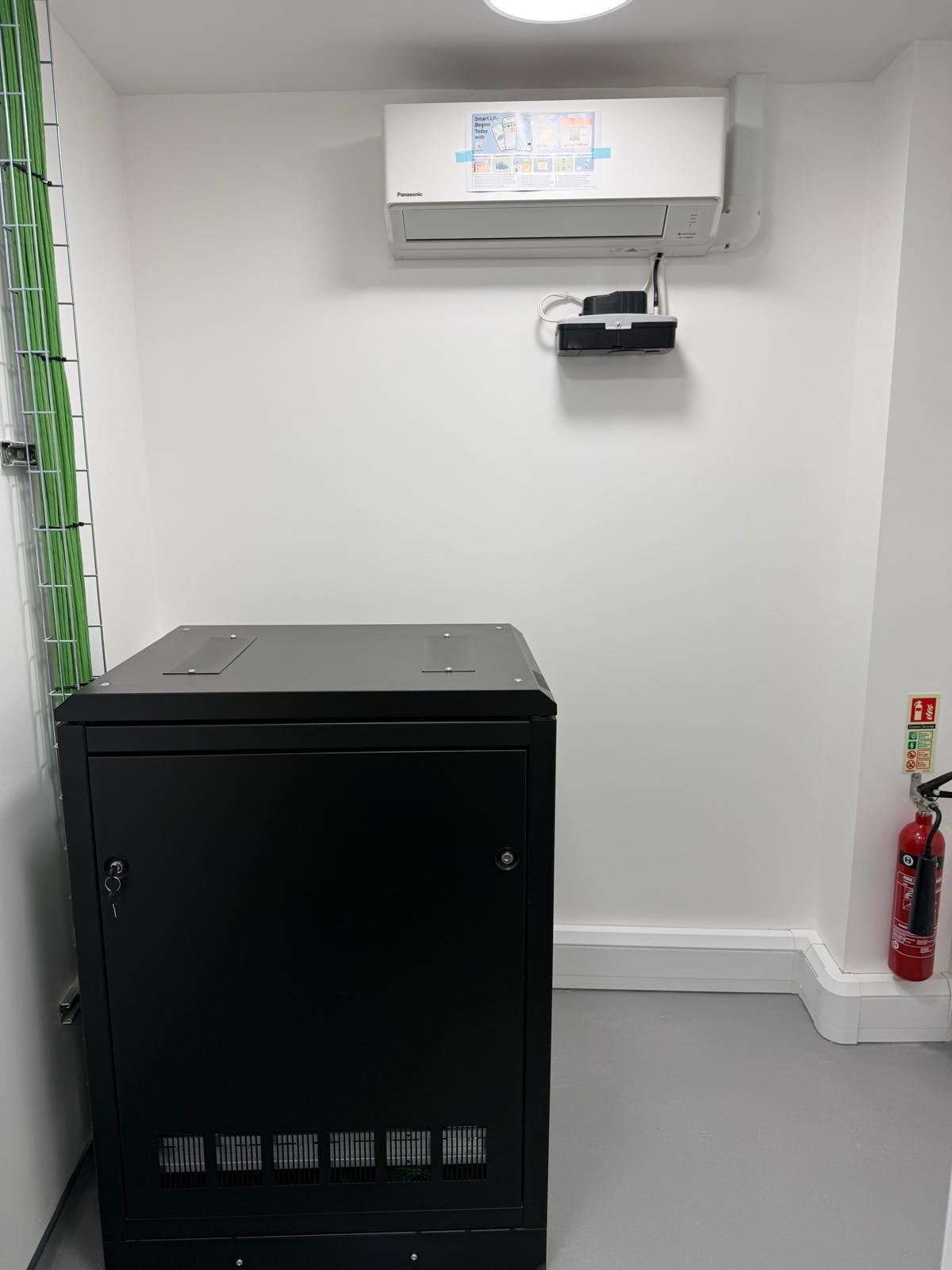 IT server room with server rack and Panasonic AC unit
