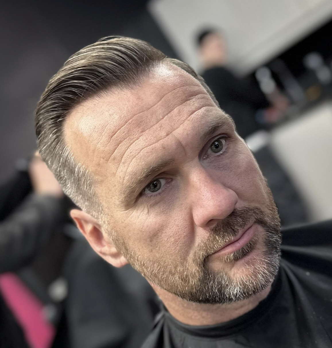 Classic slicked-back style with beard
