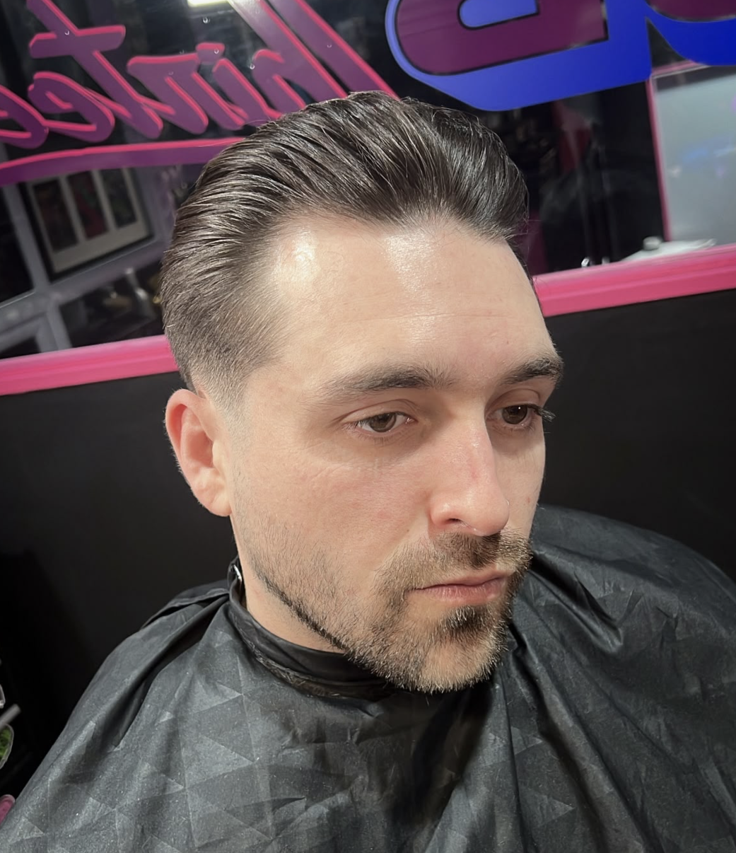 Three-quarter profile of a client with dark hair styled up and back