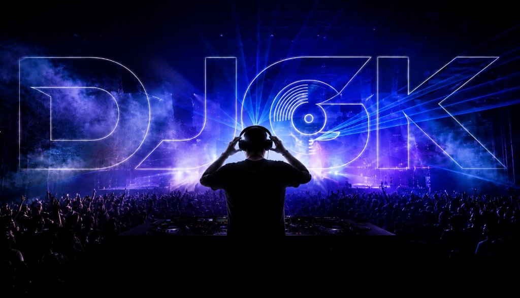 DJGK performing live on stage with massive crowd and laser lights