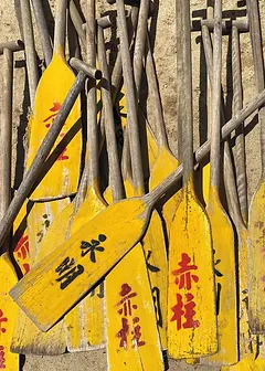 Nostalgia Card by ViewThroughJen'sLens - A close-up view of multiple yellow paddles, each displaying unique lettering and wear, reflecting their use in outdoor activities