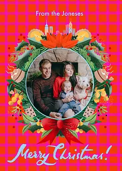 Cheerful Christmas Card by Erin Hung Studio - illustrated wreath with a blue center encircled by festive decorations, including pine, flowers, and sweets, complemented by a red bow and the greeting "Merry Christmas!" 