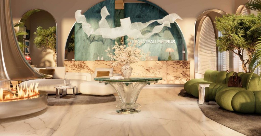 Grand lobby interior of Le Château Piétrus with sculptural lighting and marble