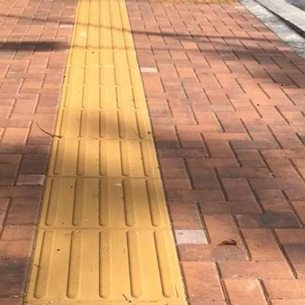Acera accesible con guía podotáctil para personas no videntes