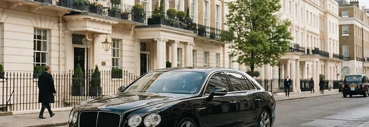 Black executive saloon on a London street with elegant Georgian architecture in bright natural daylight