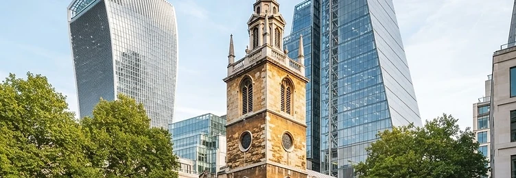City of London where modern glass towers stand alongside ancient stone churches in bright natural daylight