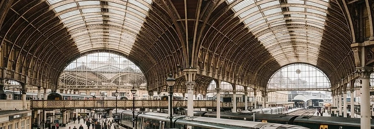 London Paddington Station with Brunel's historic Victorian train shed and iron arches in bright natural daylight