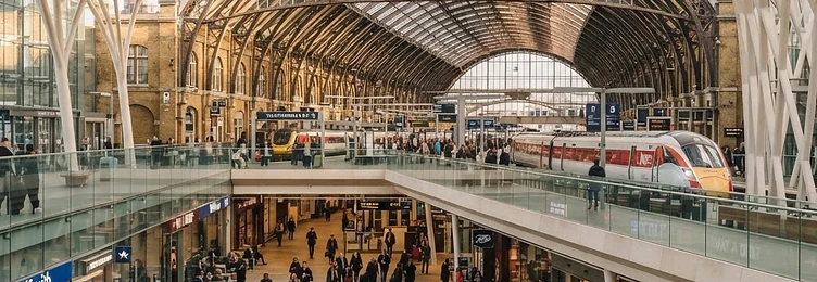 London Kings Cross Station with the iconic Victorian train shed and modern concourse architecture in bright natural daylight