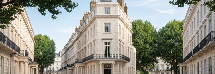 Central London streetscape with Georgian stone architecture and deep green trees in bright daylight