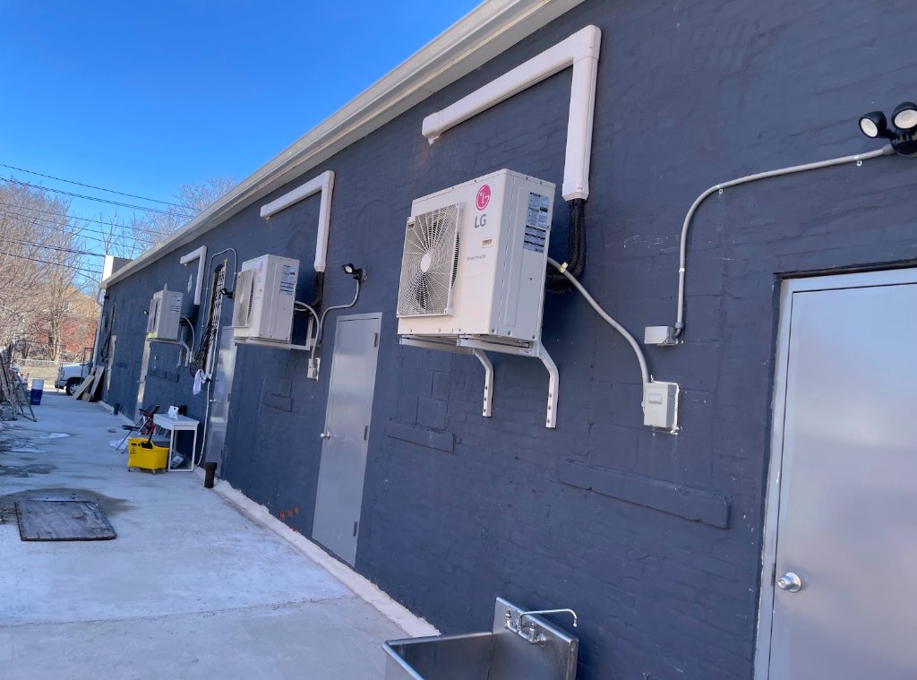 Commercial ductless mini-split condensers mounted on exterior wall by NGC Sheetmetal in Boston