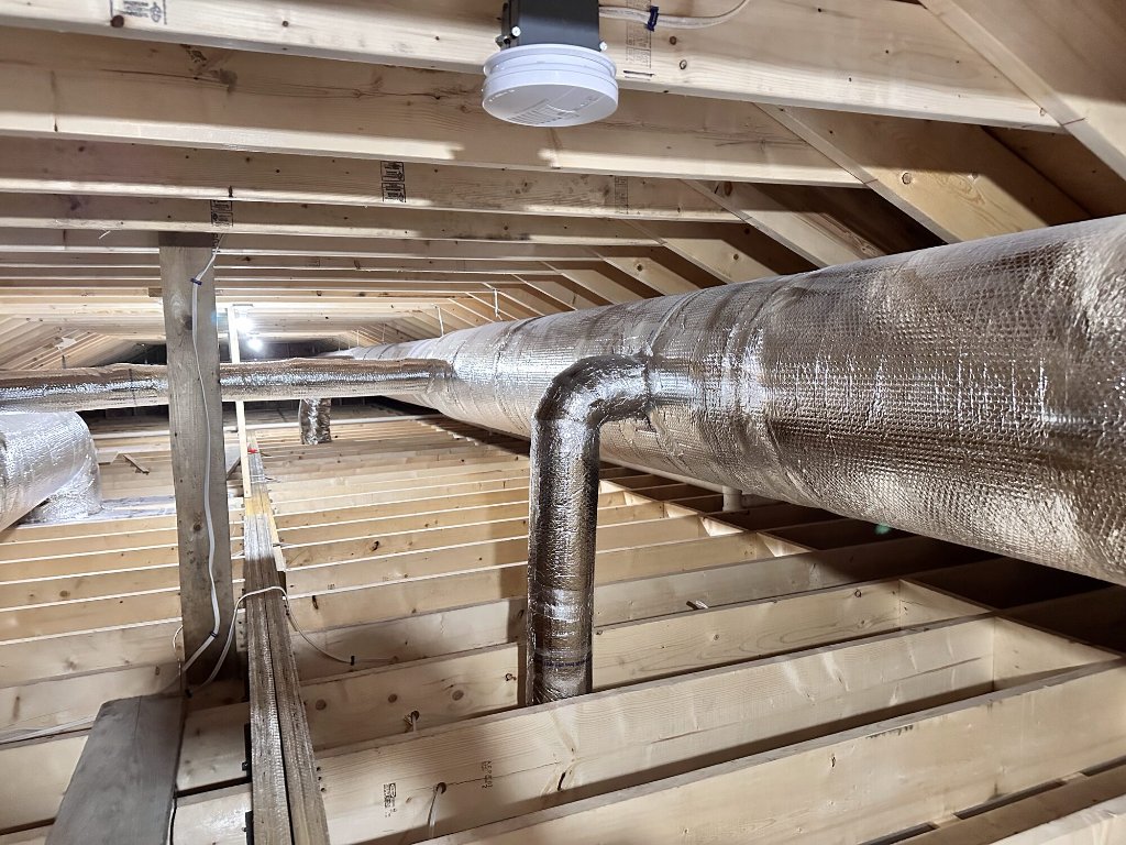 Spiral custom sheet metal ductwork installed in a Greater Boston attic by NGC Sheetmetal