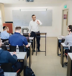 A teacher guiding students in a classroom