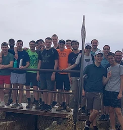 Young men on a group hike overlooking the hills of Israel