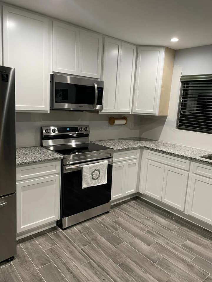 Kitchen remodel with white cabinetry and stainless appliances by CCH Construction