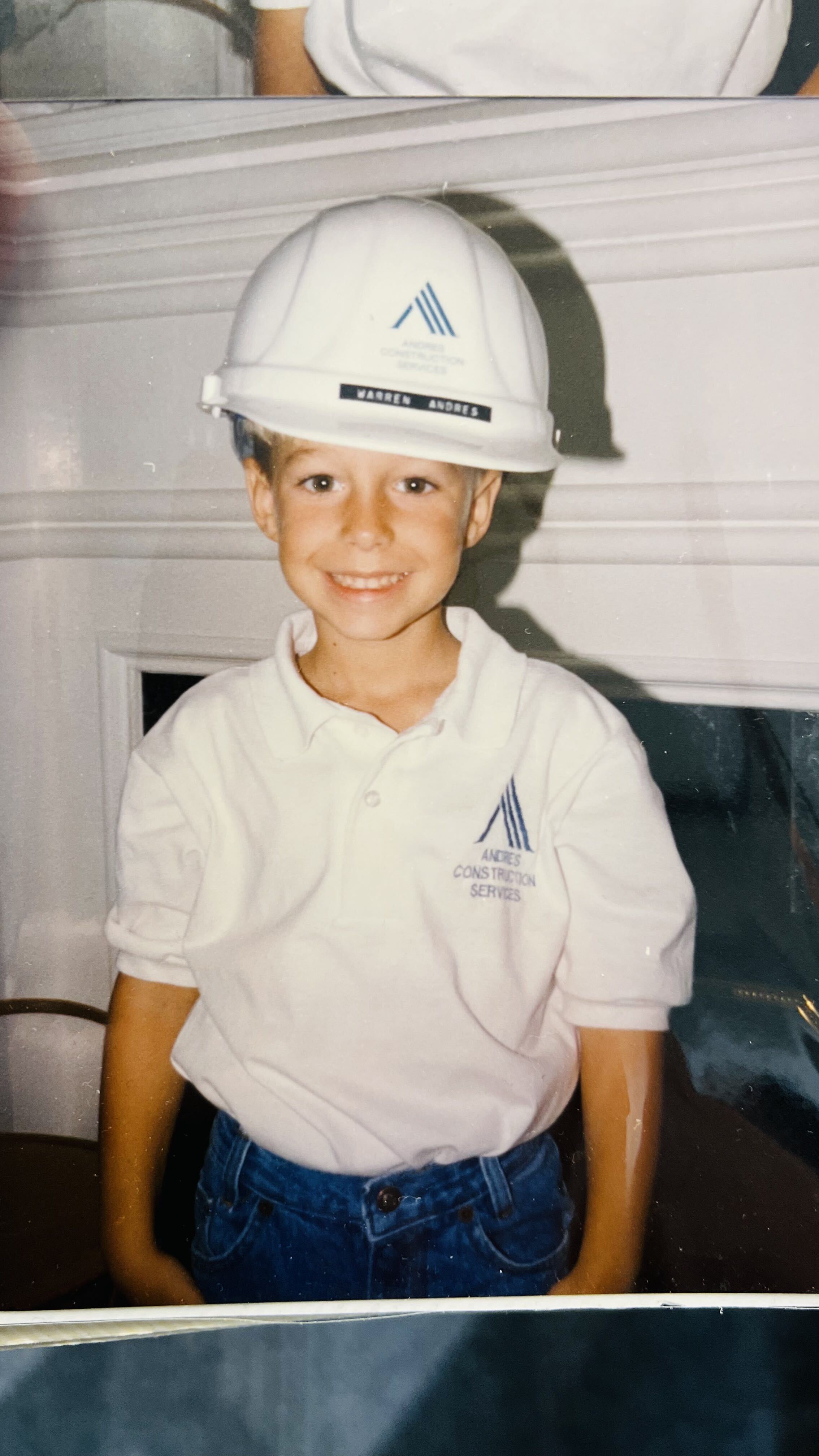 A young John Andres on the jobsite in an ANDRES Construction hard hat