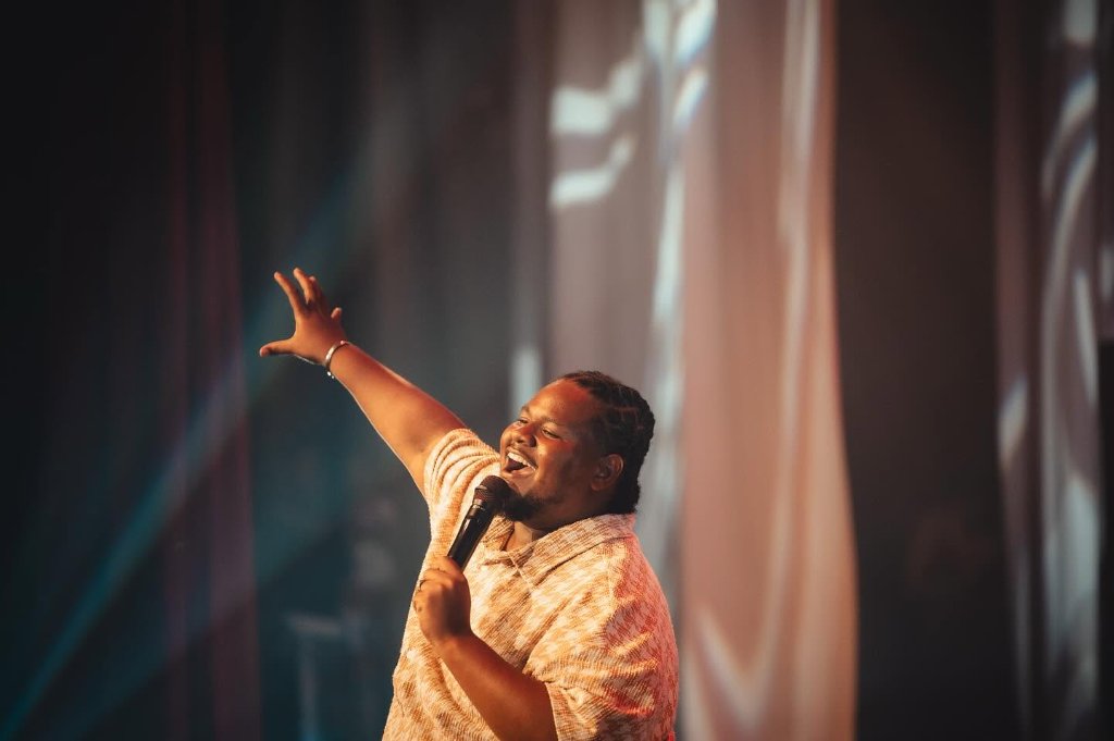 Mentor singing on stage