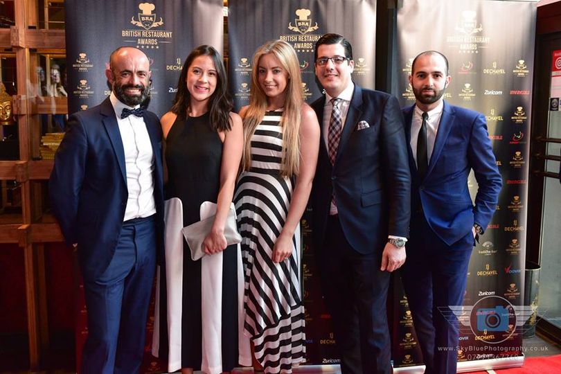 British Restaurant Awards ceremony with guests on the red carpet in front of the official branded backdrop