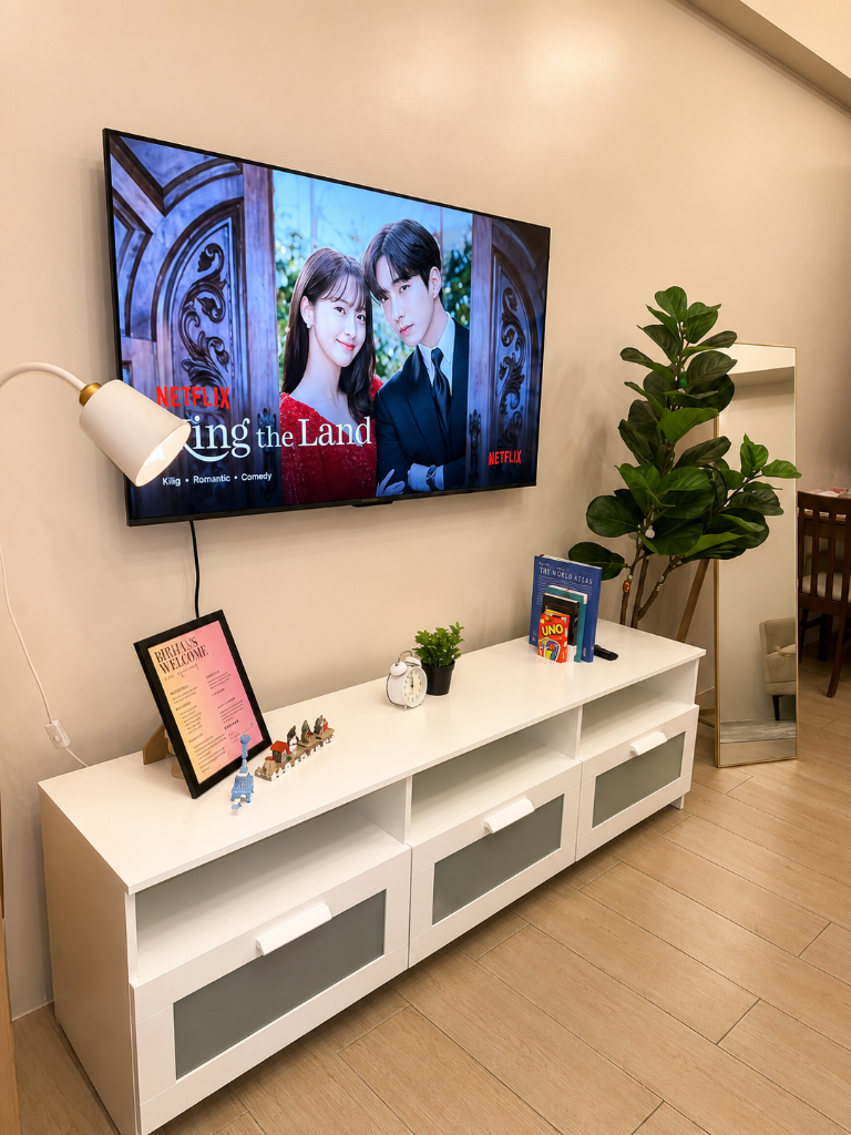 Smart TV showing Netflix with Briana's welcome board, UNO cards, and fiddle-leaf fig plant