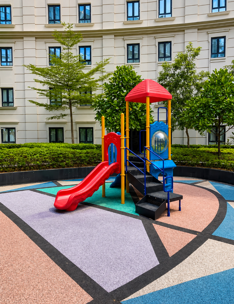 Children's playground with red slide and colourful rubber flooring at 81 Newport Boulevard