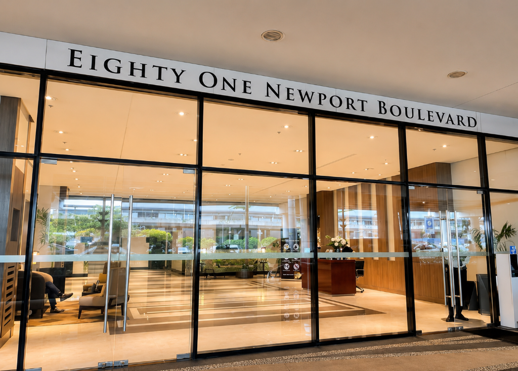Grand lobby entrance of Eighty One Newport Boulevard with marble floors and concierge desk